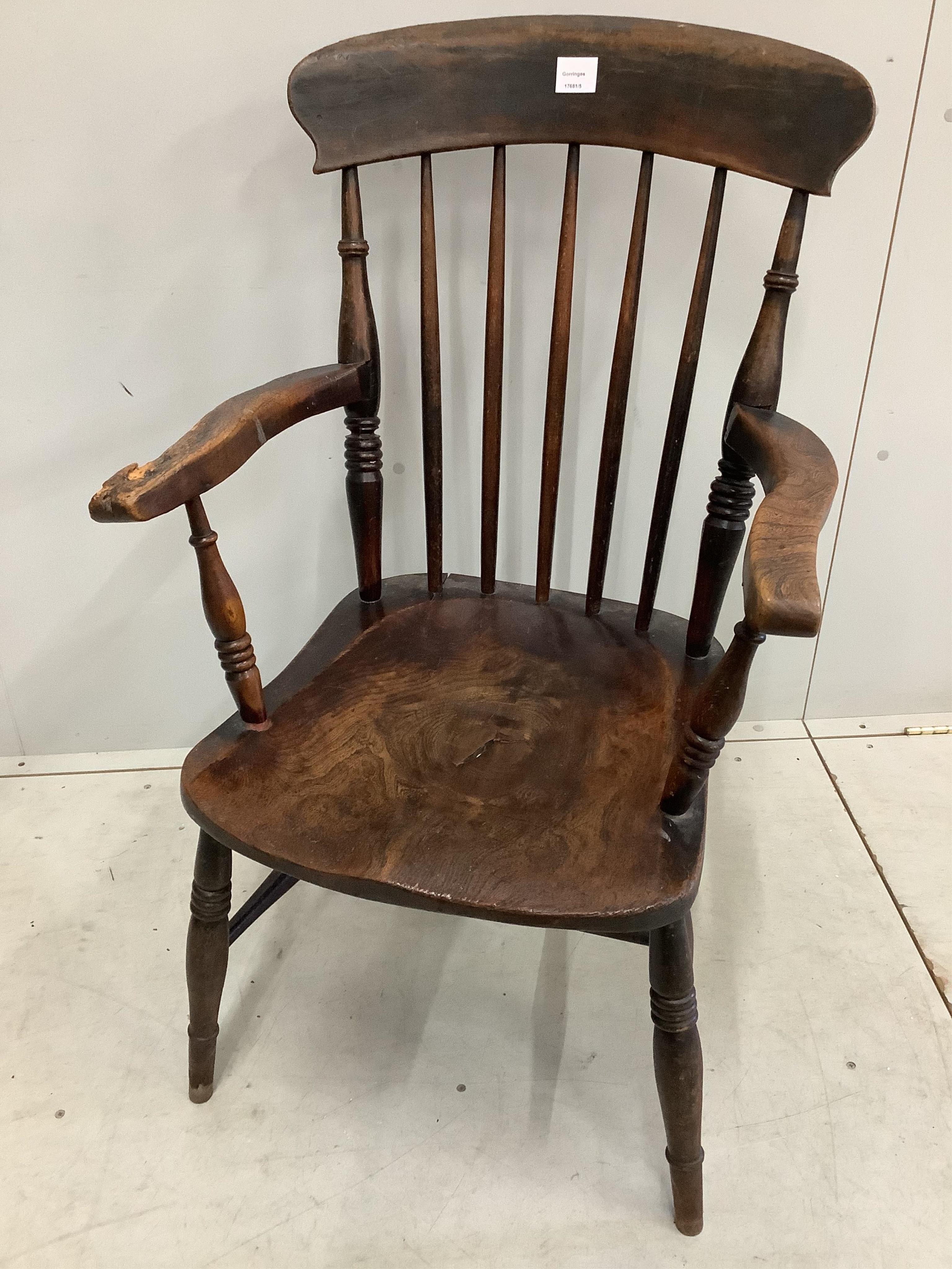 A 19th century ash and elm Windsor comb back armchair with crinoline stretcher, width 54cm, height 100cm together with a later Windsor elbow chair. Condition - poor to fair